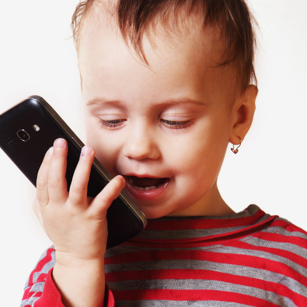 beautiful little baby girl is speaking smartphone - Foto, Bild
