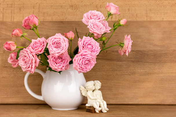 Růžové květy v bílém džbánu. - Fotografie, Obrázek
