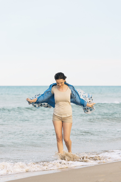 Woman walking away on the idylic beach. - Foto, Bild