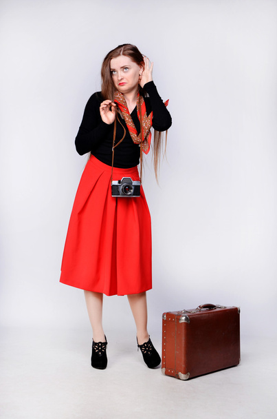 Traveling girl with a camera and suitcase - Photo, Image