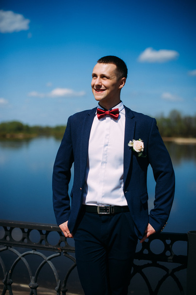 happy and beautiful groom at spring outdoors at the beach of the - Fotografie, Obrázek