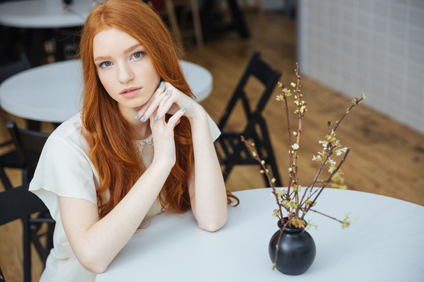 Thoughtful beautiful woman sitting in cafe  - Valokuva, kuva