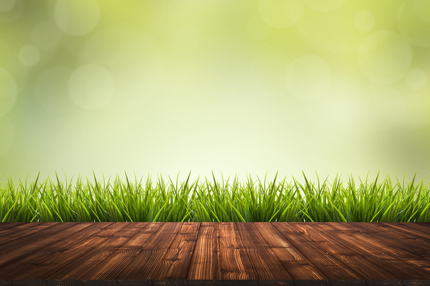 Wooden floor, grass and green blurred background - Фото, зображення