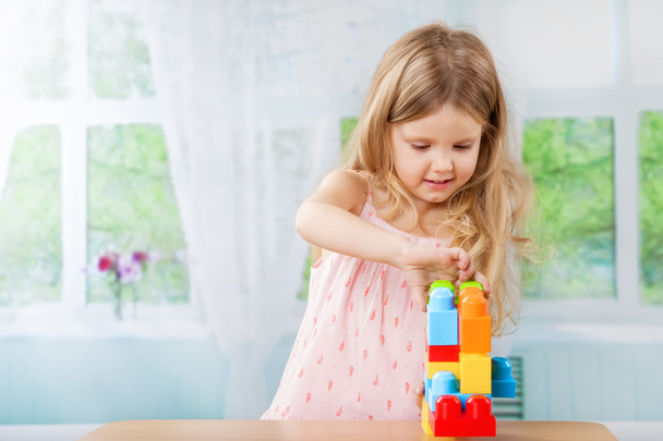 Cute girl playing with a toys - Foto, imagen