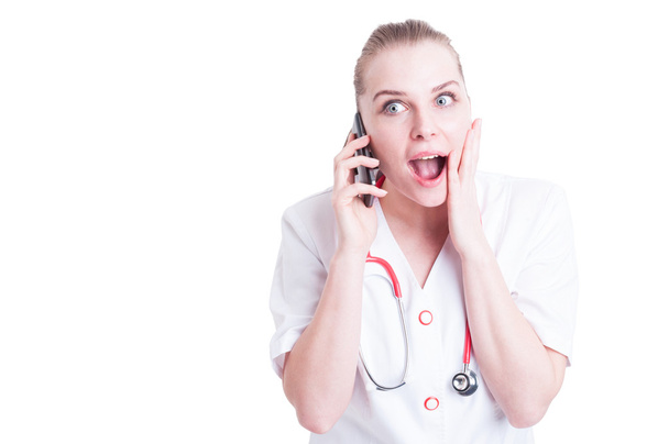 Happy surprised female doctor talking on the phone - Фото, изображение