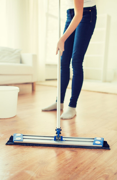 close up of woman with mop cleaning floor at home - Foto, Bild