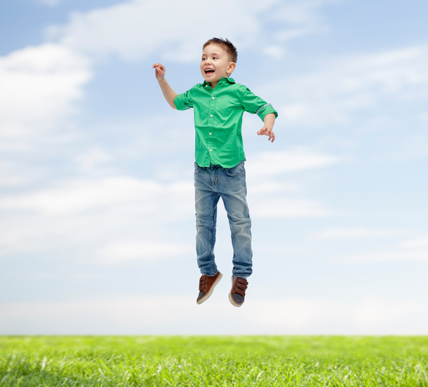 happy little boy jumping in air - Фото, изображение