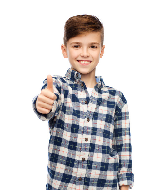 smiling boy in checkered shirt showing thumbs up - Foto, Bild