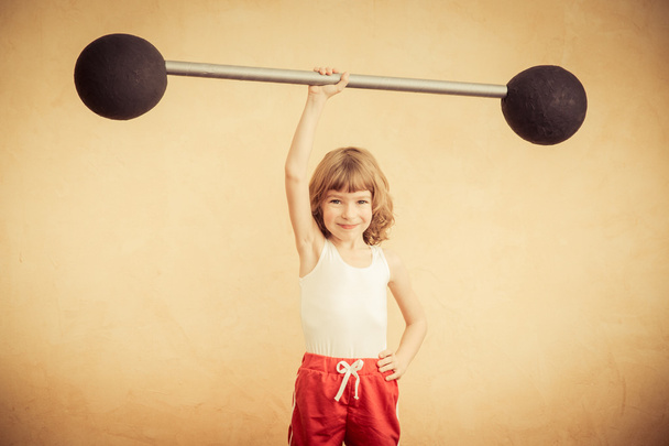 Strong child with barbell. - Foto, afbeelding