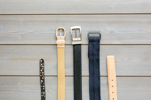 belts for men and women on the wooden background - Foto, Bild