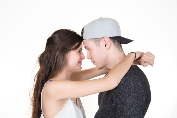 Beautiful young  couple kissing isolated over white background - Fotó, kép
