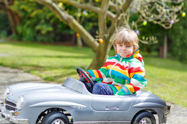 Little preschool boy driving big toy old vintage car, outdoors - Photo, Image