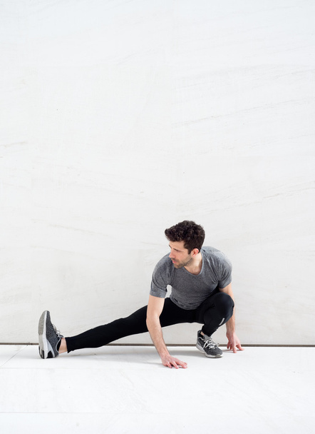 man stretches leg-Space for text - Фото, зображення