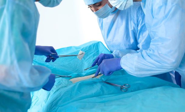 Team of surgeon in uniform perform operation on a patient at cardiac surgery clinic - Photo, Image