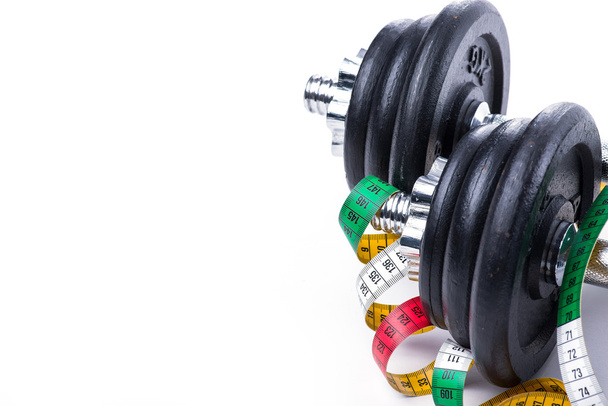 Dumbbells with measuring tape on white - Photo, Image