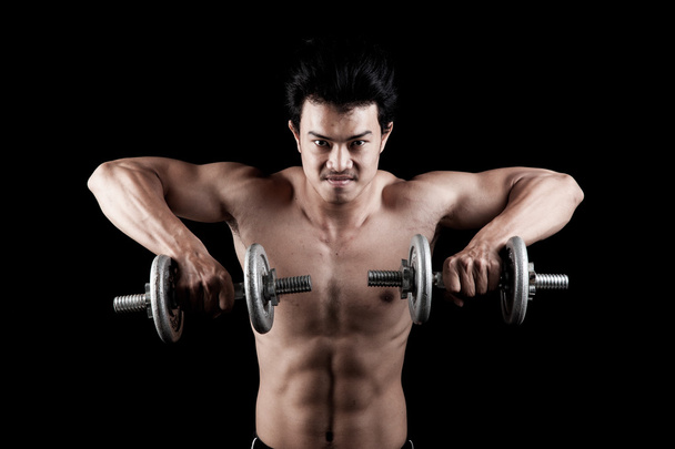Muscular Asian man with dumbbell - Foto, Imagen