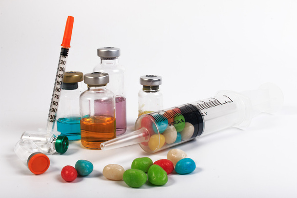 A syringe and candy bottle isolate on white background. Protect against diabetes. - Photo, Image