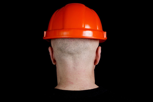Construction worker in hard hat on gray background - Foto, Bild