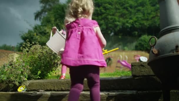 toddler twins with watering cans  - Footage, Video