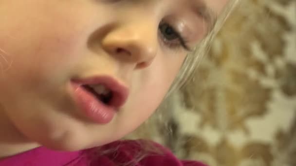 Closeup of Happy Little Girl Face Reading Emotionally. 4K UltraHD, UHD - Záběry, video