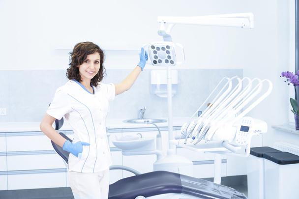 Young professional woman dentist in the dental office - Foto, Bild