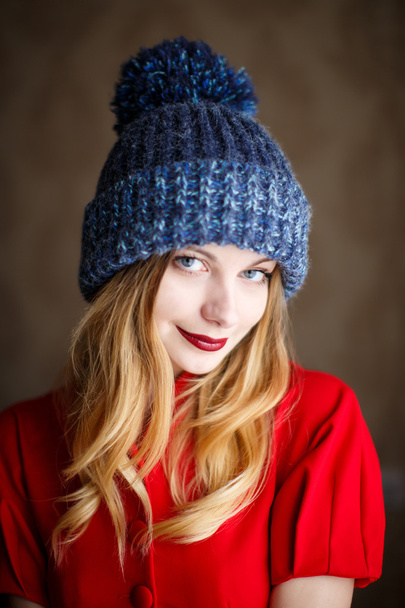 Portrait of playful woman in knitted winter cap - Фото, изображение