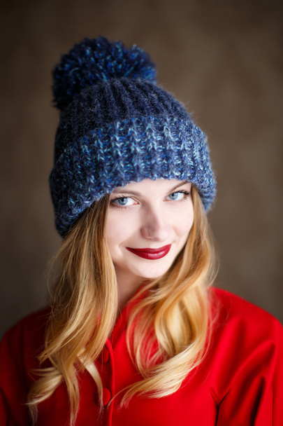 Portrait of playful woman in knitted winter cap - Фото, изображение