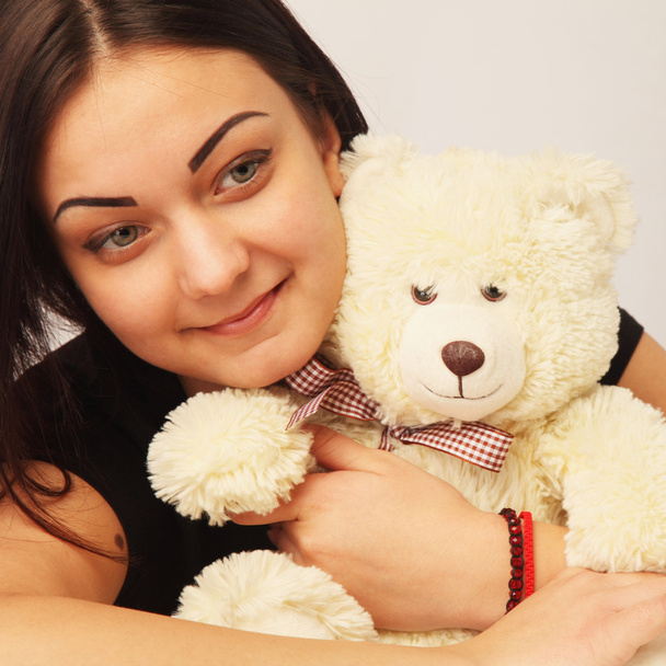 beautiful woman with Bear toy as a symbol nostalgia for the care - Fotografie, Obrázek