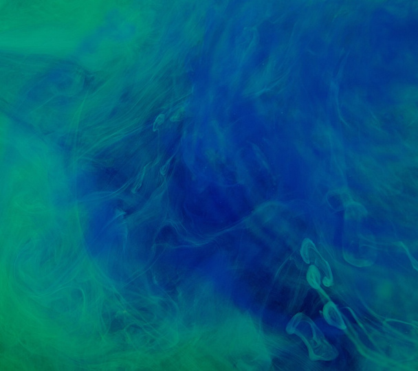 Blue green clouds of ink in liquid  - Photo, image