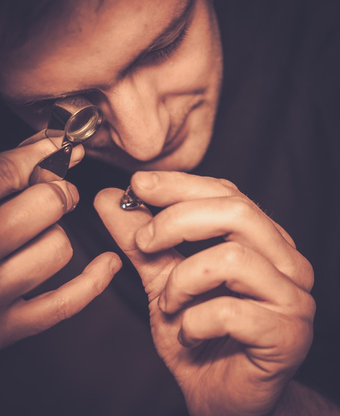 Portrait of a jeweler during the evaluation of jewels.  - Fotó, kép
