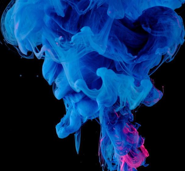 Blue pink clouds of ink in liquid isolated on black - Foto, afbeelding