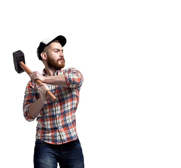 Bearded man wearing a cap hold hammer. - Photo, image