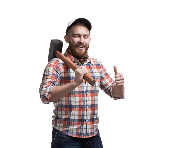 Bearded man wearing a cap hold hammer. - Foto, Imagen