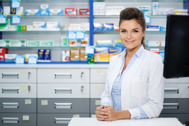 woman pharmacist doing his work in pharmacy. - Фото, изображение