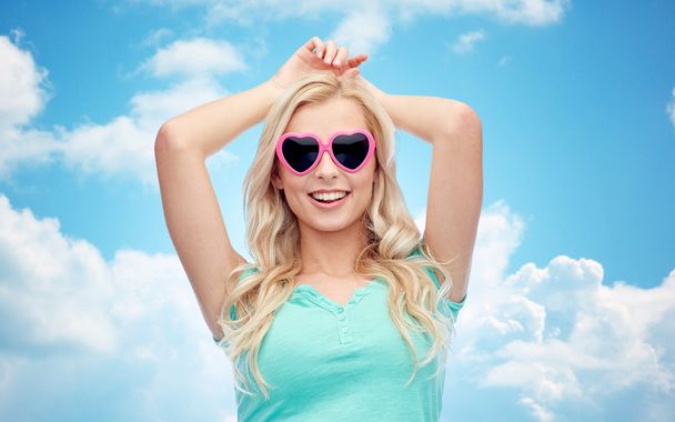 happy young woman in heart shape sunglasses - Foto, Bild