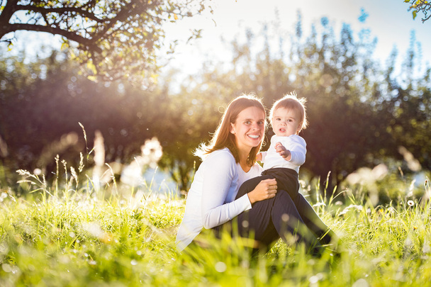 Mother with little son on grass - Zdjęcie, obraz