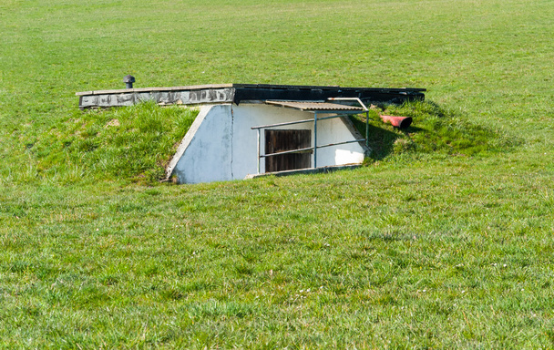 outdoor scenery showing a bunker in overgrown grassy ambiance - Photo, Image