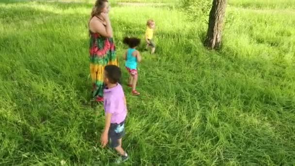 girl in dress and three kids  - Filmati, video