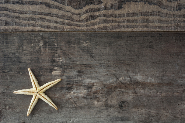 Starfish on a rustic wood background - Photo, Image