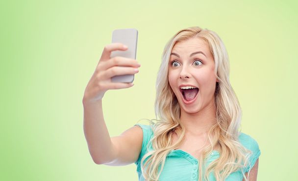 smiling young woman taking selfie with smartphone - Foto, Imagem