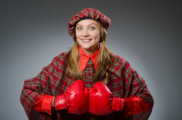 Woman in scottish clothing in boxing concept - Photo, Image