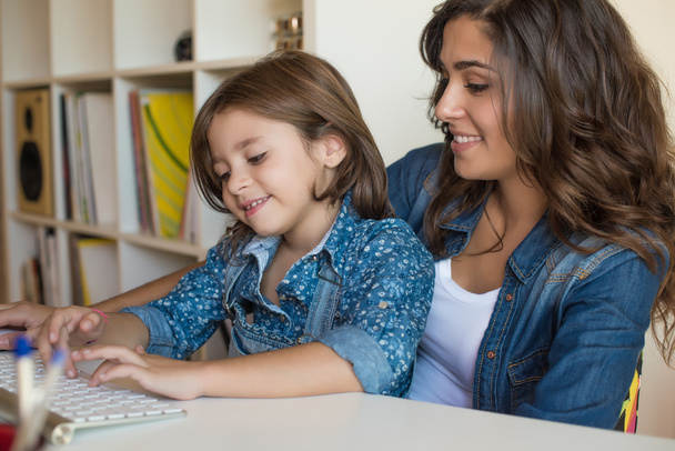 woman with girl using computer - Photo, Image