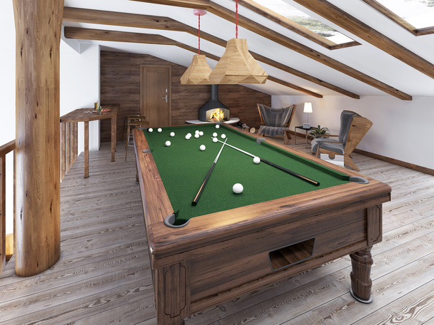 Billiard room in the attic with sitting area and fireplace. - 写真・画像
