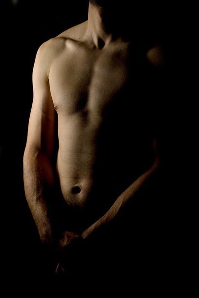 Low key image of male body - Zdjęcie, obraz