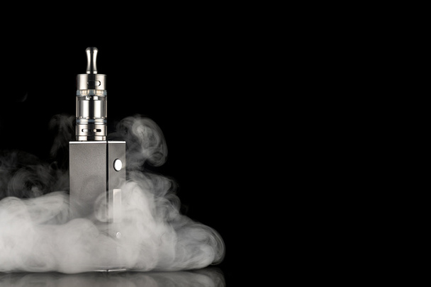 electronic cigarette over a dark background - Photo, image