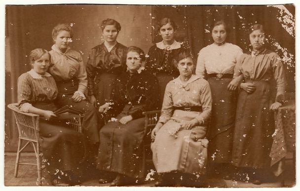 Vintage photo shows group of women pose at the photography studio. Black & white antique photography. - Photo, Image