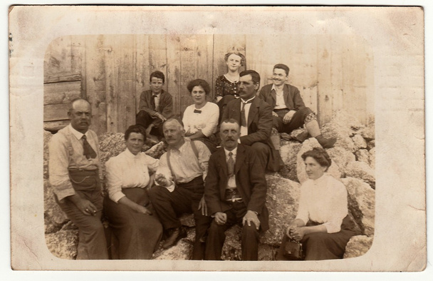 Photo vintage montre un groupe de personnes assises dans la cour arrière. Photographie antique noir & blanc
. - Photo, image