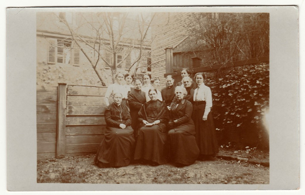 Vintage photo shows women pose in the back yard. Black & white antique photography. - Photo, Image