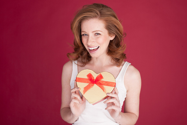 female with red hair holding heart shape - Photo, Image