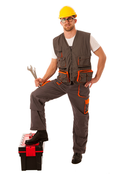 Happy Worker standing on Toolkit And holding  Wrench Over White  - Photo, image